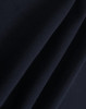 A close-up of dark navy polar fleece fabric showing soft, smooth texture folds. It features a branding logo.