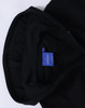 A black full-zip fleecy hoodie with a hood and a label inside.