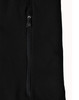 A close-up of a black softshell jacket featuring a zipped pocket and a branded logo.