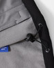 A close-up of a black men's softshell full zip hoodie interior, featuring a grey fleece lining and adjustable drawcord.