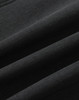 A close-up of a black softshell fabric with a smooth texture, featuring folds and creases.