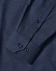 A men's long sleeve button-up shirt in navy with a pin dot pattern and cuff details. Features a logo.