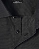 A close-up of a men's black pin dot stretch short-sleeve shirt featuring a slim fit and a collar with buttons.