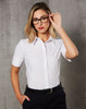 A white women's cotton/poly stretch short-sleeve button-up shirt with a collar, worn by a model.