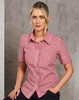 A red and white gingham short-sleeved button-up shirt worn by a model, featuring a branded logo.