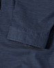 A navy blue button-up shirt featuring a pin dot pattern and 3/4 sleeves, with a folded cuff detail.
