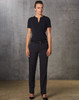 A woman wearing black Women's Flexi Waist Utility Pants, paired with a matching top, standing against a textured background.