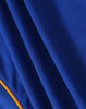 A close-up view of a blue polo shirt with an orange trim, featuring a textured fabric and a logo.