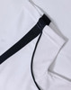 A white polo shirt with black accents, featuring a logo. The fabric has a textured, breathable appearance.