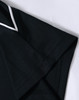 A black polo shirt featuring a collar and cuff detail, with a subtle logo on the sleeve.