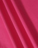 A close-up of textured fabric in a vibrant pink colour, showcasing its structure and weave.