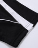 A black polo shirt with white detailing and a logo, featuring a textured fabric design.