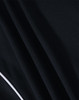 A close-up of a black fabric featuring textured folds, part of a Ladies S/S Sport Polo shirt with a branding logo.