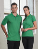 A green men's polo shirt paired with a matching green polo shirt for women, both featuring a logo.