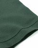 A close-up of a dark green cotton stretch polo shirt, featuring a neat hem and smooth texture.