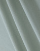 A close-up of light green cotton fabric, featuring a textured weave suitable for polo shirts.