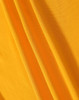 A close-up of yellow fabric featuring a textured weave, showcasing its smooth and soft surface.