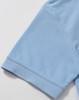 A light blue polo shirt sleeve featuring a smooth finish and a logo on the front.