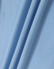 A close-up of light blue fabric, showcasing the texture and folds of a polo shirt material.