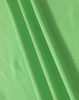 A close-up of soft, textured fabric in vibrant green, showcasing the material of a polo shirt.
