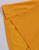 A close-up of a yellow polo shirt featuring folded sleeves and a logo.