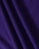 A close-up of purple fabric with a textured surface, showing folds and the material's weave.