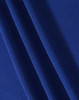A close-up of textured fabric in a rich blue colour, featuring multiple folds for visual interest.