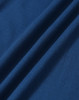 A close-up of a textured fabric in deep blue, featuring soft drapes and folds. The fabric is suitable for polo shirts.