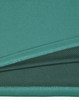 A close-up view of a teal bamboo charcoal polo shirt, showcasing its textured fabric. The shirt features a logo.