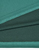 A fabric close-up of a teal bamboo charcoal polo shirt, featuring textured and dotted patterns.