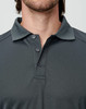 A charcoal grey men's long-sleeve polo shirt with a collar and three buttons, featuring a logo.