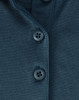 A close-up of a dark teal polo shirt featuring three buttons and a textured fabric. The shirt has a logo.