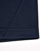 A close-up of a navy blue polo shirt featuring contrast stitching and a logo.