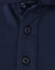 A close-up of a navy blue polo shirt featuring a button placket and a small logo.