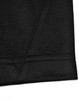 A close-up of a black polo shirt with a contrast sleeve hem and stitching detail. Features a logo on the side.