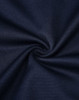 A close-up of navy fabric, showcasing its smooth texture and weave pattern, with a subtle swirl effect.