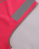 A bright pink safety vest featuring reflective shoulder tapes and contrasting grey edging. It includes a logo.