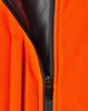 A close-up of an orange quilted safety jacket featuring a black zipper and lining. It has a logo on the fabric.