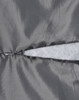 A close-up of a grey quilted fabric featuring a zippered section and a soft, light grey lining.