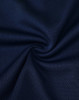 A close-up of navy fabric with a textured mesh pattern, suitable for polo shirts. The image features a logo.