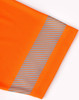 An orange polo shirt featuring segmented reflective detailing along the sleeve. It has a logo on the fabric.