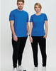 Two models wearing blue t-shirts and black poly/cotton terry sweat pants, standing side by side against a light background.