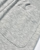 A close-up of grey poly/cotton terry fabric featuring a large pocket on sweat pants.