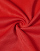 A close-up of red fabric with a textured, lightweight appearance suitable for performance wear.