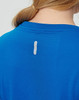 A blue ladies' short-sleeved performance T-shirt featuring a small logo on the back.