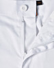 A close-up view of white unisex utility stretch cargo work pants showcasing the waistband and button detail.