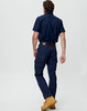 A man wearing navy lightweight semi-fitted Cordura work pants, paired with a navy shirt and brown work boots.