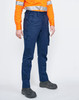 Unisex cotton stretch ripstop work pants in navy blue, featuring multiple pockets and a logo. Worn with an orange high-visibility shirt.