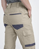 Cuffed unisex work pants in khaki, featuring multiple pockets and a waistband with elastic. Includes branding.