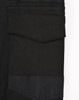 A close-up of black cotton stretch drill cuffed work pants, featuring pockets and a logo.